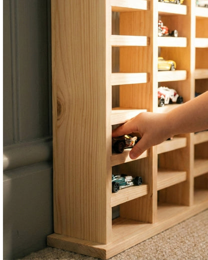Wooden wine rack with a hand selecting a bottle of wine.