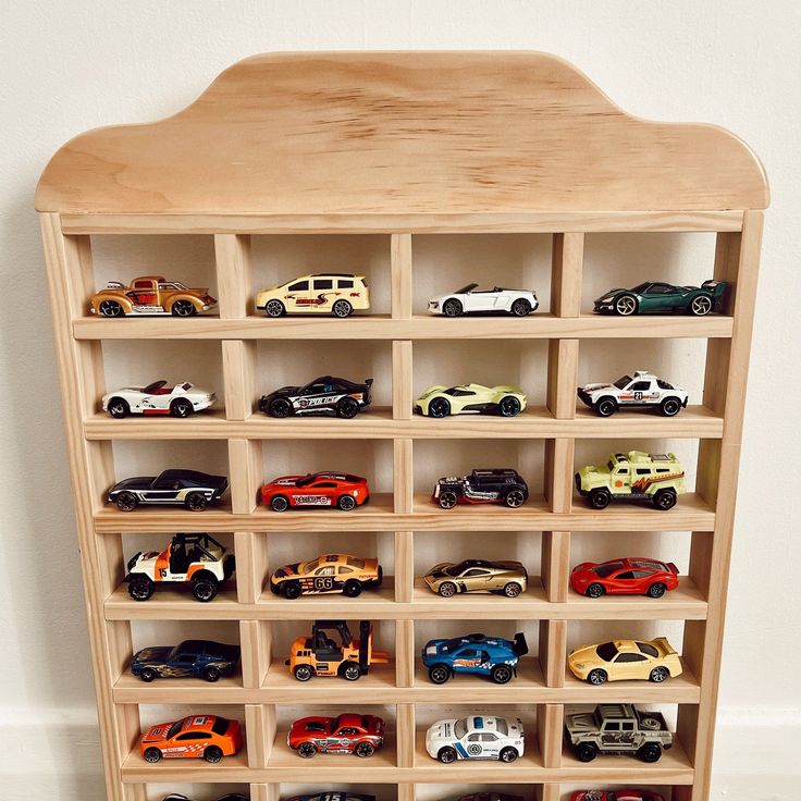 Hot Wheels cars neatly arranged in Montessori-style wooden display
