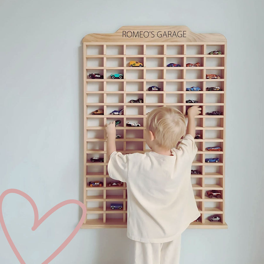 Child playing with wooden toy car garage, perfect for eco-conscious families
